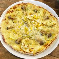 Pizza with corn, potato, mushrooms, white sauce.  at Vegans Cafe and Restaurant in Kyoto