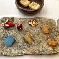 Selection of cheeses with kumquats, radish and marinated cherry  at DaiCa in Mallorca