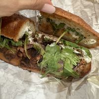 Flores sandwiches on gluten free bun  at Maciel's Plant-Based Butcher & Deli in Los Angeles