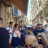 Behind the guy with white t shirt next to the girl with blue skirt is the line for take away at Pizzeria da Michele in Naples