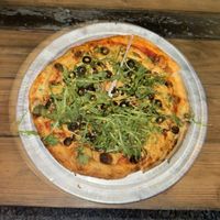 CYO pizza: traditional dough, tomato sauce, vegan cheese, black olives, spinach, fresh basil, arugulaa  at Magdalenes Pizza in Aguadilla