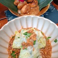 Twee voorgerechten; gadogado koolrolletjes en bakabana op een stokje. at Papa Aswa in Amsterdam