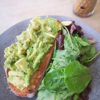 Avocado toast with green leaves mini salad at Sweet Studio in Madrid