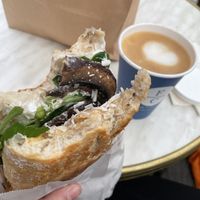Vegan sandwich: chickpeas, dried paprika, vegan cheese, mushrooms, vegan mayo and salad leaves + cappuccino with oat milk  at Father Carpenter in Berlin