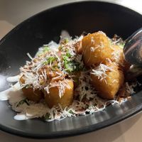 On the specials menu. Although they look like tater tots, they are far from it. Light and fluffy potatoes with vegan crafted bacon and Parmesan. ::chef’s kiss::  at Crossroads Kitchen in Las Vegas