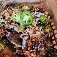 Half eaten second order of nachos.  Had to take the picture fast before it was gone! at JDs VegMex in Miami