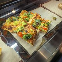 Filling pizza with thick fluffy base and vegan cheese at Cristina's kitchen in Mechelen