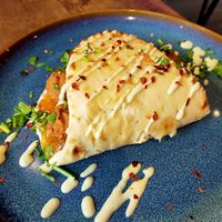 Naan Wrap with Vegan Sausages, chutney and spices  at The Chakra Lounge in Bakewell