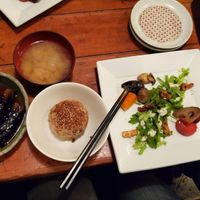 Left is eggplant with ginger sauce, on the right is the dinner set with miso soup, vegetables and rice bowl at Mominoki House in Tokyo