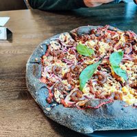 Vegan Pizza with black crust. at Black Crust Pizzeria in Vik
