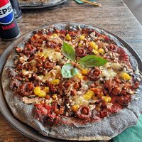 Vegan Black Crust pizza, no onion, changed for orange at Black Crust Pizzeria in Vik