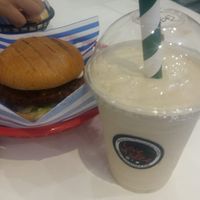 Spicy veg burger, and Skittles oat milkshake; one of 6 vegan flavours at Love A Slice in Beckenham