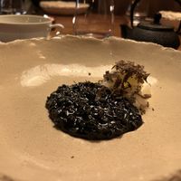 Daikon, shaved truffle, charcoal-colored risotto  at Encanto in Lisbon
