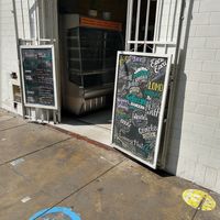 Entryway with menu boards at Loving Hut Lince in Lima