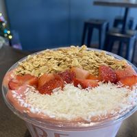 A build-your-own smoothie bowl topped with shredded coconut, strawberries, and granolaa  at BARE Blends in Latham