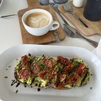 Avocado and sun-dried tomato’s on toast, and oat milk flat white   at Fika in Liverpool