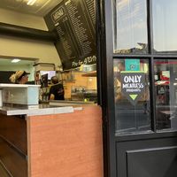 Small sign on the door indicating that they have meatless products (mega meatless brand)  at Pita Fan in Rhodes