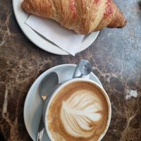 raspberry croissant and flat white with oat milk at EDI - Caffé Nero in Edinburgh
