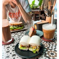 Banh bao, banana bread, chocolate+peanut butter+banana smoothie, iced coffee with soy milk and sandwich 🤍  at Chickpea Eatery Thuan Chay in Hoi An
