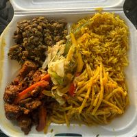 Meatloaf, lentils, rice, cheesy type spaghetti medium plate some cabbage and veggie salad on top. 4/1/26 at Amore Arowako Vegan Club in St John