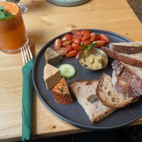 Vegan cheese plate with roasted bread and fig mustard and freshly pressed juice at drei&zwanzig in Karlsruhe