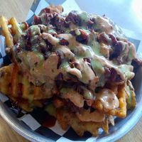Loaded waffle fries topped with BBQ jackfruit and a bunch of sauces at Twisted Plants in Milwaukee