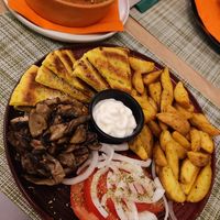 baked vegan feta and aubergine on top, gyros plate with mayo at the bottom at Veganissimo in Santorini