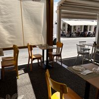 Outdoor seating next to main road   at Veganissimo in Santorini