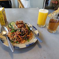 The fried noodle, pineapple juice and welcoming tea at Thong Dong Vegan Kitchen & Cafe in Lao Cai