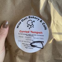 Curbside vegan bagged lunch! I chose the curried tempeh wrap. Comes with chips, vegan chocolate chip cookie, and a bottle of water. at Wild Oats Bakery and Cafe in Brunswick