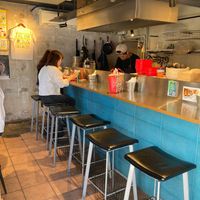 Some chairs at the bar and there are a few on the left out of view.  at Qué Pasa - Downtown in Kyoto
