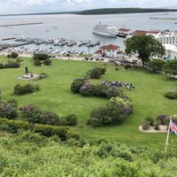 The view from our porch table Uber a bright yellow umbrella   at Fort Mackinac Tea Room in Mackinac Island