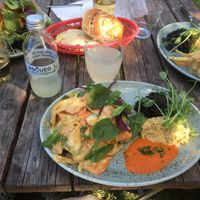 Potato salad (Also carrot in it) mixed with a mustard vinaigrette with hummus, tapenade and a red sauce. A cardamom bun and a bamsing in the basket. at Cafe Victoria in Uppsala