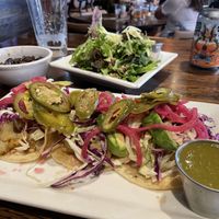 Seared Cauliflower Tacos with a side Rod salsa verde. Side salad shown in background    at Crave Kitchen & Bar in El Paso