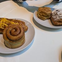 Sausage, egg and cheese; cinnamon roll (frosting not shown); biscuit; bear claw at Flour + Time Bakery in Atlanta