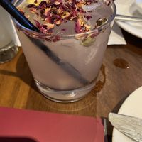 Rose Long Vodka - lemon-infused vodka, bitters, cardamom pods, and rose lemonade with rose petals garnish  at David Bann Restaurant in Edinburgh
