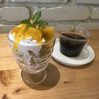 Vegan dessert with mango, whipped cream, cake and granola on the bottom. Plus coffee  at nagi in Nagoya