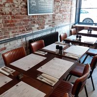 Nice and open, love the exposed brick, there are green velvet chairs at the BACK to avoid leather chairs....(you can request the back tables) at The Steakist in Arundel