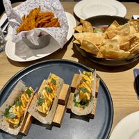 Sweet potato fries, guacamole dip and tofu taco sushi  at Earls Kitchen + Bar in Toronto