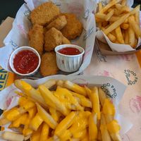 Nuggets, cheese fries, and normal fries in the back at The Sunny Burger Co. in Amsterdam