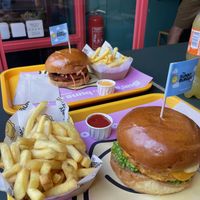 Crispy fried chick‘n burger and Nashville hot chick‘n  burger plus fries and ketchup and cheddar sauce 🍔  at The Sunny Burger Co. in Amsterdam