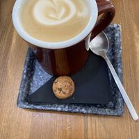 Oat latte - with non vegan cookie piece 🙁  at Monk Coffee in Rhodes