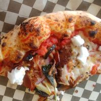 Half-eaten Fun Guy (will upload a better pic later LOL!): tomato sauce, mushrooms, vegan pepperoni, goat cheese, basil, onion, garlic, truffle oil at Rawr Goods in Panama City