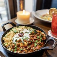 Oriental couscous pan with chickpeas, sweet potato, zucchini, aubergine, tomato, vegan yogurt and fresh mint  at Nichtschwimmer in Bielefeld