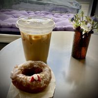 Delicious maple oat milk latte and yummy vegan donut at the Green Beautiful 💚  at The Green Beautiful  in Manchester