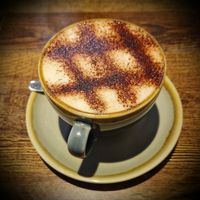 Cappuccino with vegan chocolate and oat milk at Sociale Cafe in West London