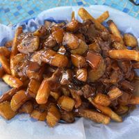 Vegan loaded fries, delicious! Jackfruit and sweet plantains with two amazing sauces- tangy bourbon and spicy sweet guava!  at Cultural Kitchen Catering in Jacksonville