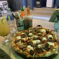Meat lovers pizza and passion fruit margarita   at Pizzasaurus in Cape Town
