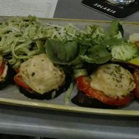 Vegetarian Melanzani-tomato-sheep cheese cake with fettuccini in green pesto and steamed vegetables at Gelbes Krokodil in Linz