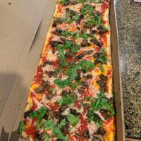 A large mushroom pizza substitute vegan cheese wowww look at the length  at Jules Thin Crust Pizza in Jenkintown